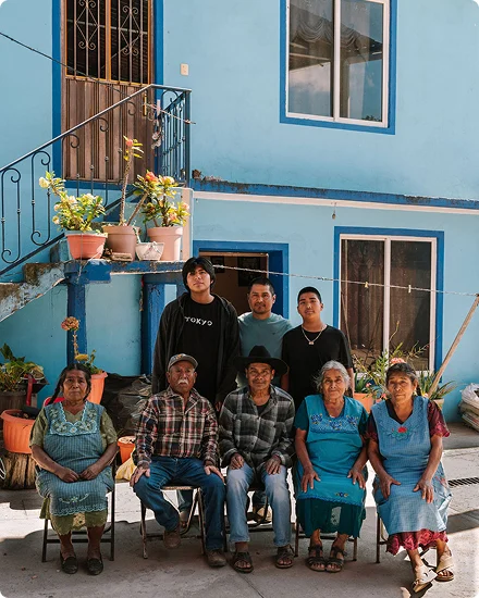 A mezcalero family outside their blue home